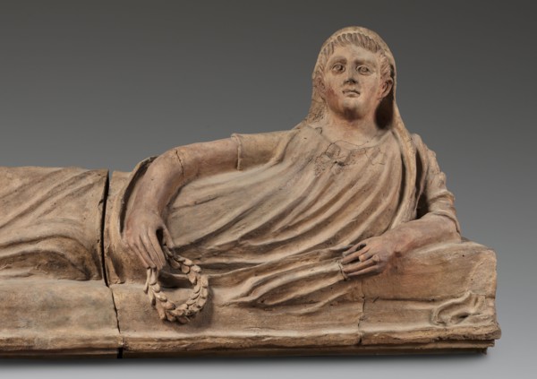 Sarcophagus lid;, The deceased is shown in a semi-reclining position, resting his left forearm on a