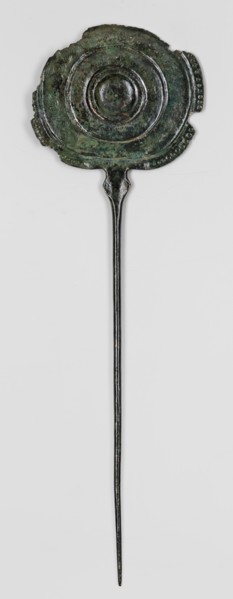 Pin, unknown Luristan workshop. A long pin terminating in a head in the form of an oval shield with