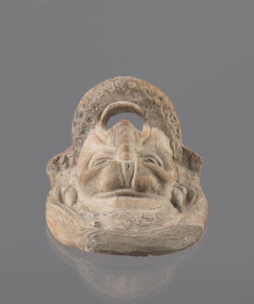 Tragic mask, terracotta, 4th/3rd century BC, Southern Italy. Tragic mask depicting a male face,