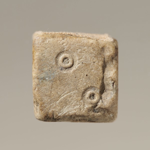 Six-sided dice with pips 1–6 shown as hollow circles and dots; material unspecified; maker and