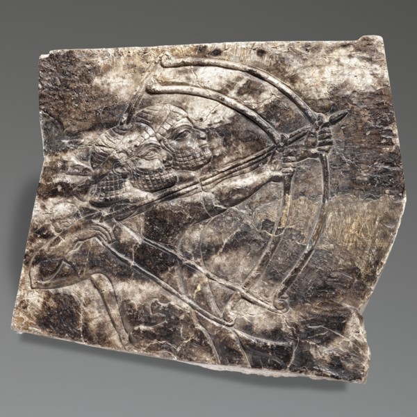 Fragment of an orthostat with relief decoration, unknown Neo-Assyrian workshop. Fragment of a stone