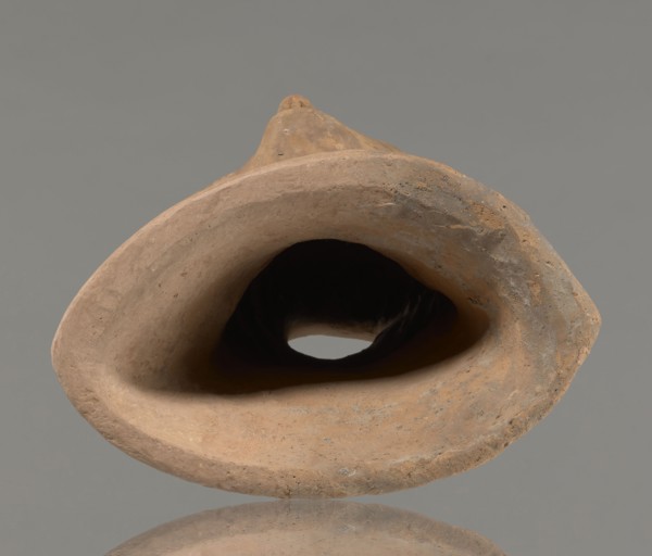 Votive female head, Female head wearing a wreath, from under which lush locks of hair curl down the