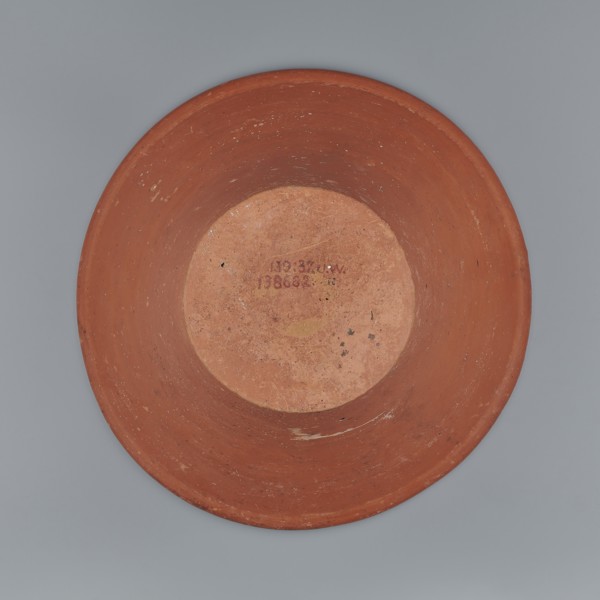 Deep, cup-shaped clay bowl with a slightly convex bottom and sides arching upwards, straight