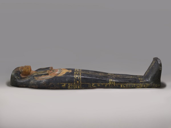 Lid of an anthropoid sarcophagus of a woman with clearly modeled legs. The head is sculpturally