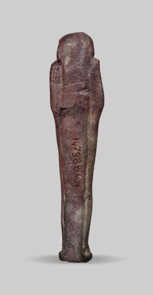 Ushabti, A shabti figurine dressed in a shroud stands on a base. On the head is a smooth wig