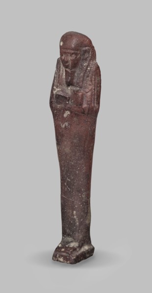 Ushabti, A shabti figurine dressed in a shroud stands on a base. On the head is a smooth wig,