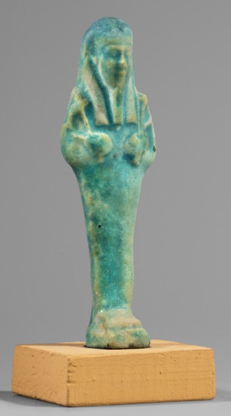 Ushabti; Mummy-shaped funerary figurine standing on a base, supported at the back by a flat