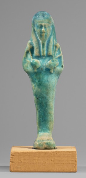 Ushabti. Mummy-shaped funerary figurine, standing on a base, supported at the back by a flat