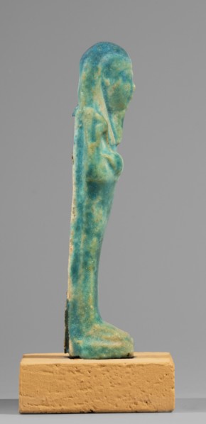 Ushabti, mummy-shaped funerary figurine standing on a base, supported at the back by a flat