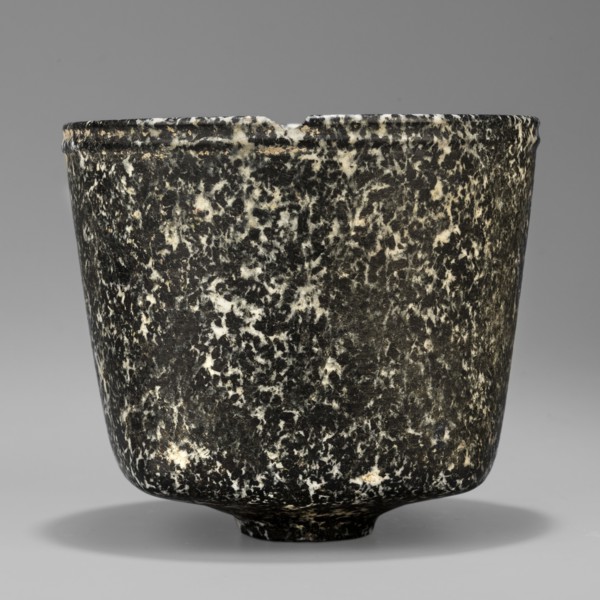 Stone vessel. Vessel with a quadrangular bottom and an almost cylindrical body profiled below the