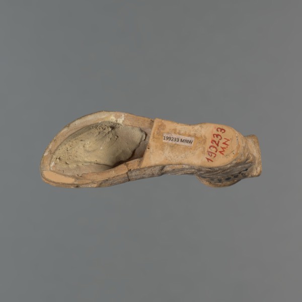 Foot-shaped aryballos, aryballos, antique vessel. Yellow-orange clay with mica; matte black engobe