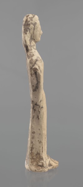 Terracotta figurine of a woman, unknown Boeotian workshop. Female mold-pressed figurine standing in