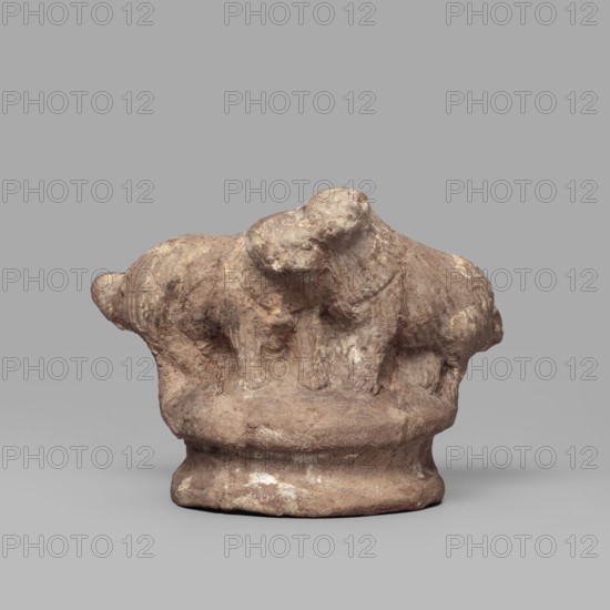 Two dogs, Two dogs shown schematically on a round, profiled base. The dogs are shown standing, with