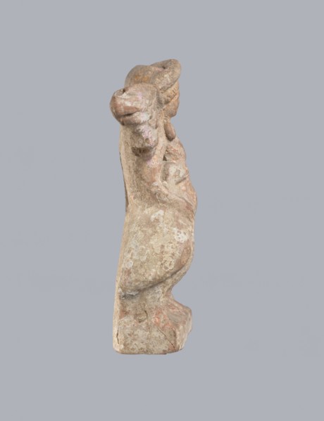 Terracotta figurine of Eros with a goose. Terracotta, figurine from a mold, figurine of a standing