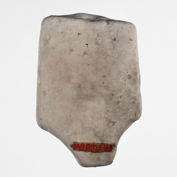 Fragment of a figurine of a woman on a bed. Flat figurine of a concubine resting on a plate