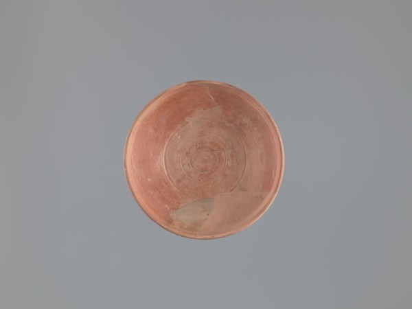 Plate, unknown Aswan workshop; flat plate on a low, ring-shaped foot. Rim poorly defined, rounded