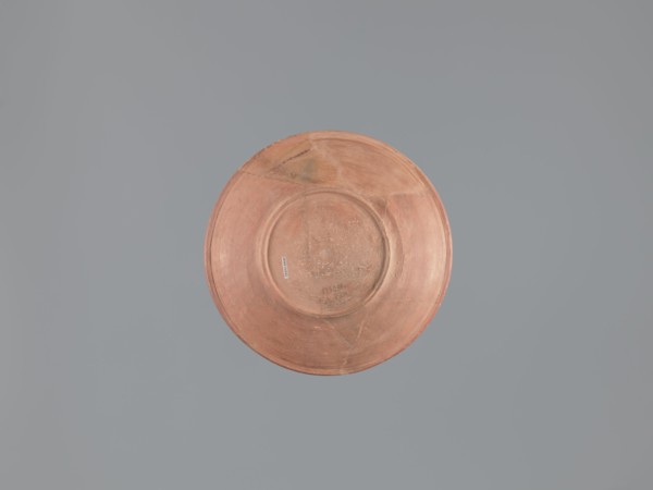 Plate, unknown Aswan workshop; flat plate on a low ring-shaped foot. Rim poorly defined, rounded at
