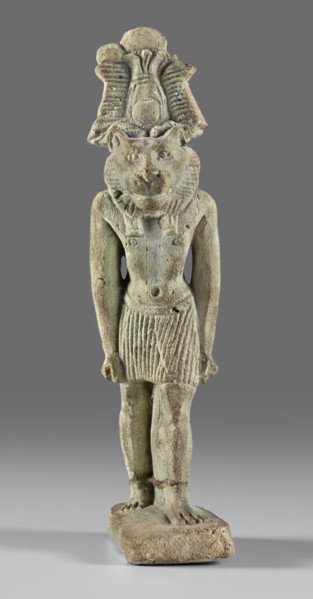 Amulet - god Mahes. Figurine of a striding lion-headed male deity wearing an atef crown, dressed in