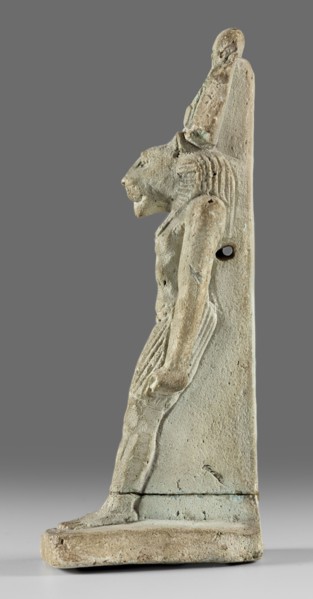 Amulet - god Mahes. Figurine of a striding lion-headed male deity wearing an atef crown, dressed in