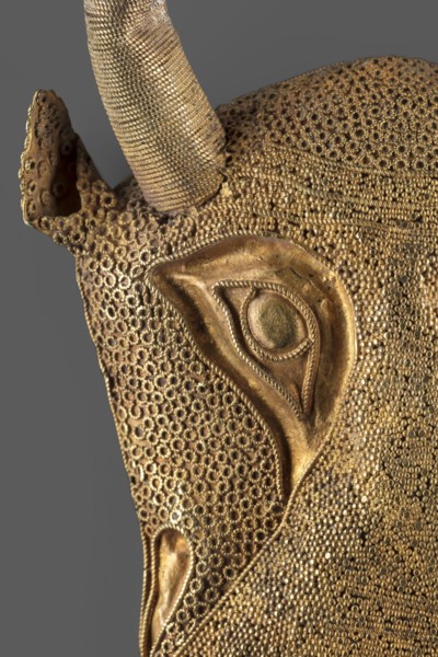 Protoma; bull's head relief mask made in gold using repoussé, granulation, and filigree; eyes,
