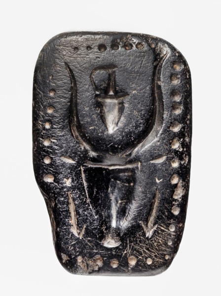 Stamp seal with a depiction of a bull's head. Stamp seal with a full, arched handle with a