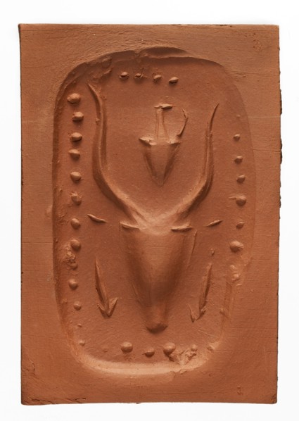 Stamp seal with a depiction of a bull's head, unknown Cypriot workshop. Stamp seal with a full,