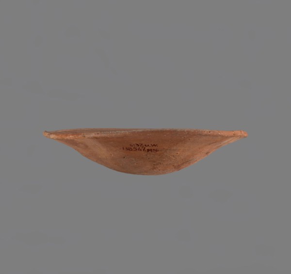 Bowl. Low bowl with irregular, strongly flaring walls and a rounded bottom. Rounded rim, slightly