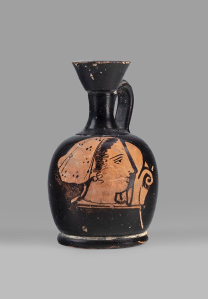 Aryballus lekythos with a depiction of a woman's head in a cap, ca. 400 BC, Attica, vessel