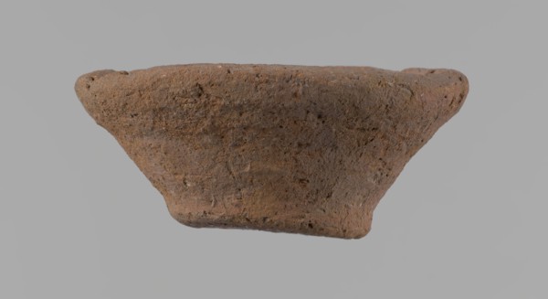 Bowl, probably votive, conical shape with flat bottom. Irregular walls; straight, slightly flaring