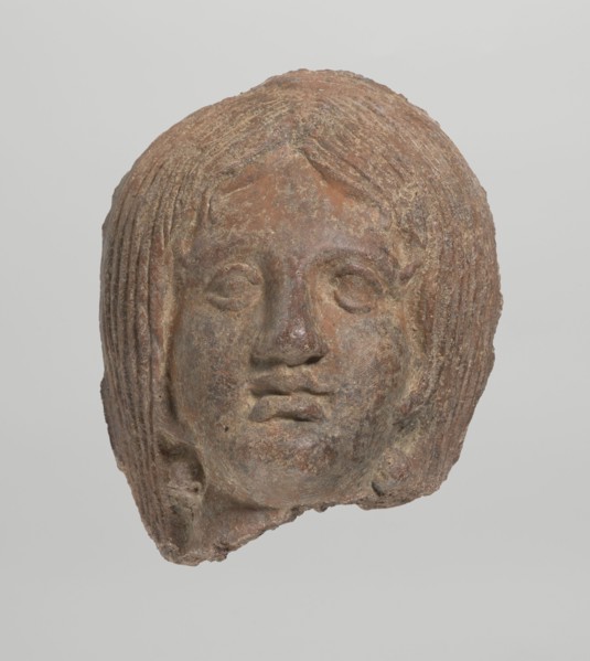 Female votive head, Female head with long, straight hair falling to the shoulders. Neck partially