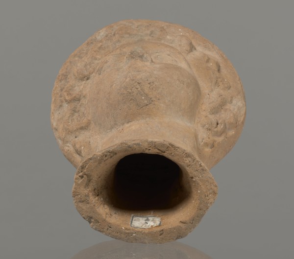 Female votive head, Female head in a wreath, slightly tilted to the right shoulder. Under the