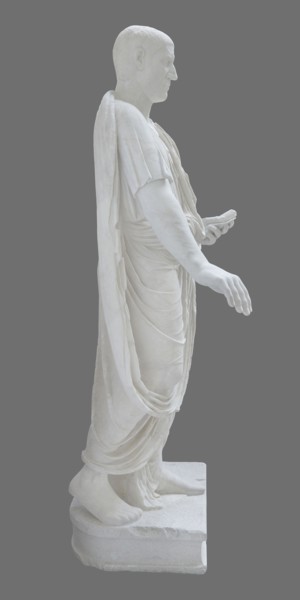 Roman statue, unknown Roman workshop. Figure of a striding man dressed in a tunic and toga. The