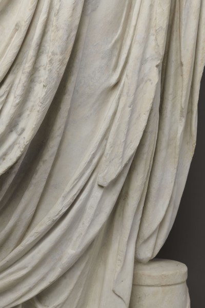 Roman statue, unknown Roman workshop. Figure of a striding man dressed in a tunic and toga. The