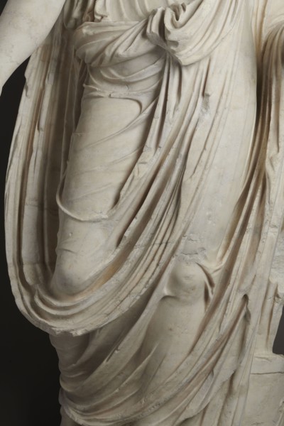 Roman statue, unknown Roman workshop. Figure of a striding man dressed in a tunic and toga. The