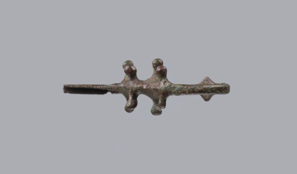 Fibula a Drago, One-piece bronze fibula with an arched ring of circular cross-section bearing four