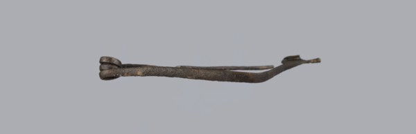 Fibula, bronze Etruscan fibula with a bent ring made of flatly beaten wire, passing in a three-turn