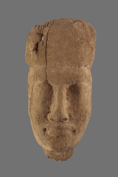 Sarcophagus mask with fragment of a wig above the forehead and a preserved piece of the neck. Very