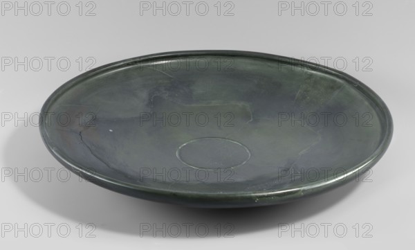 Plate, shallow stone plate with a convex bottom and a strongly flaring bowl; wide rim bent inward.