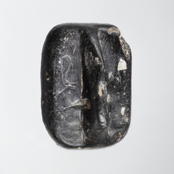 Rectangular stamp seal with a handle in the form of a protruding ridge along the axis of the seal