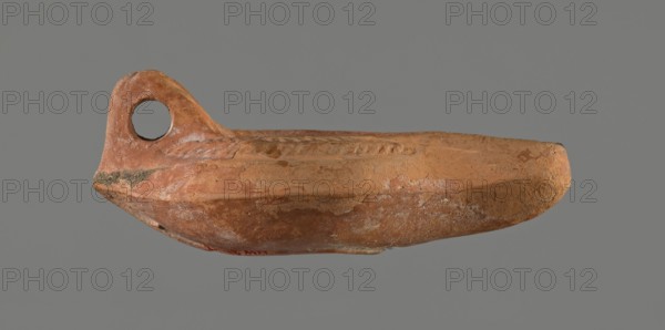 Oil lamp, 5th century, Carthage; oil lamp; height 5.3 cm, width 8.7 cm, depth 13.6 cm, A weathered
