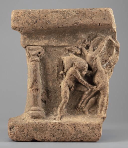 Fragment of an arula home altar depicting a satyr with a wineskin and a maenad with a drum;, Satyr