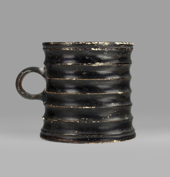 Dice cup. Small cup with a flat slightly concave bottom, slightly tapered walls, distinct rim and