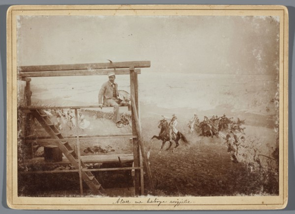 Painting the Raclawice Panorama: Wojciech Kossak with a palette on scaffolding next to a part of