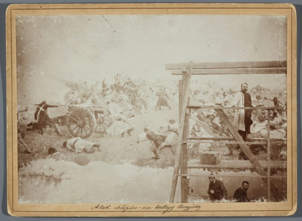 Painting the Raclawice Panorama: Jan Styka standing on scaffolding by a section of the canvas