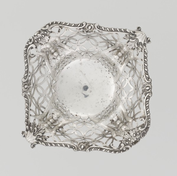 Openwork basket by Comyns & Sons London; goldsmiths' firm, fl. 1859–1953. Openwork basket on a