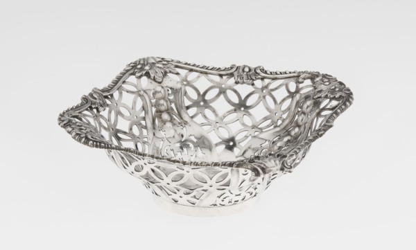 Openwork basket by Comyns & Sons goldsmiths’ firm, active 1859–1953. Four-sided openwork basket on