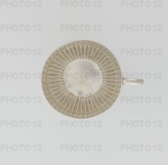 Hemispherical cup and saucer, decorated with radiating curls to half its height, with a C-shaped