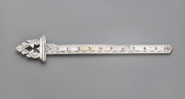 Ruler with a handle composed of interconnected acanthus twigs forming a triangle. Measuring