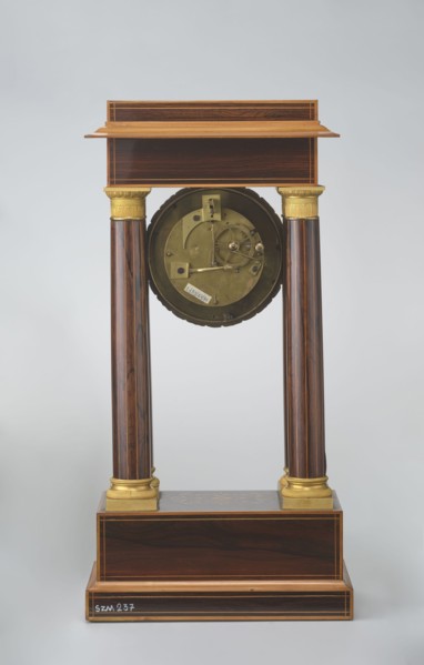 Mantel clock by Alexandre Pertrand fl. ca. 1840. Four-column portico form on a cuboid base and