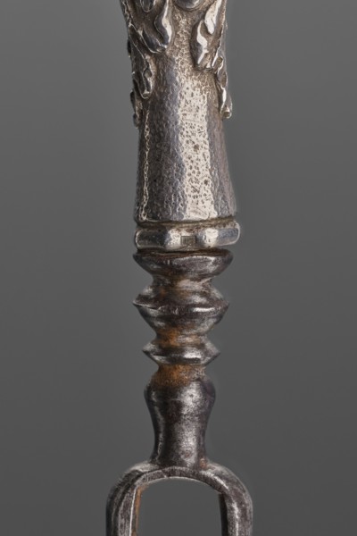 Fork. Two-pronged steel fork with a silver handle shaped as a full-plastic female herm. Unmarked.